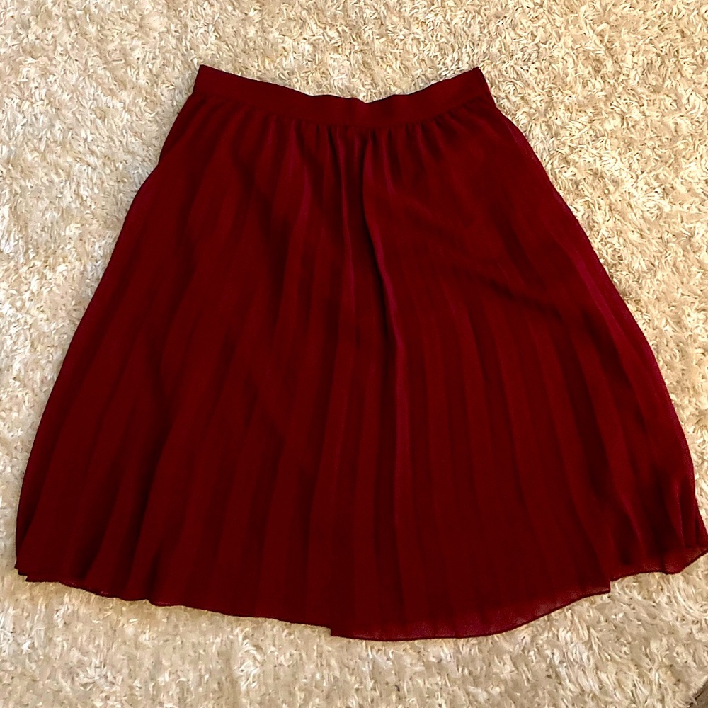 Knee length pleated maroon skirt